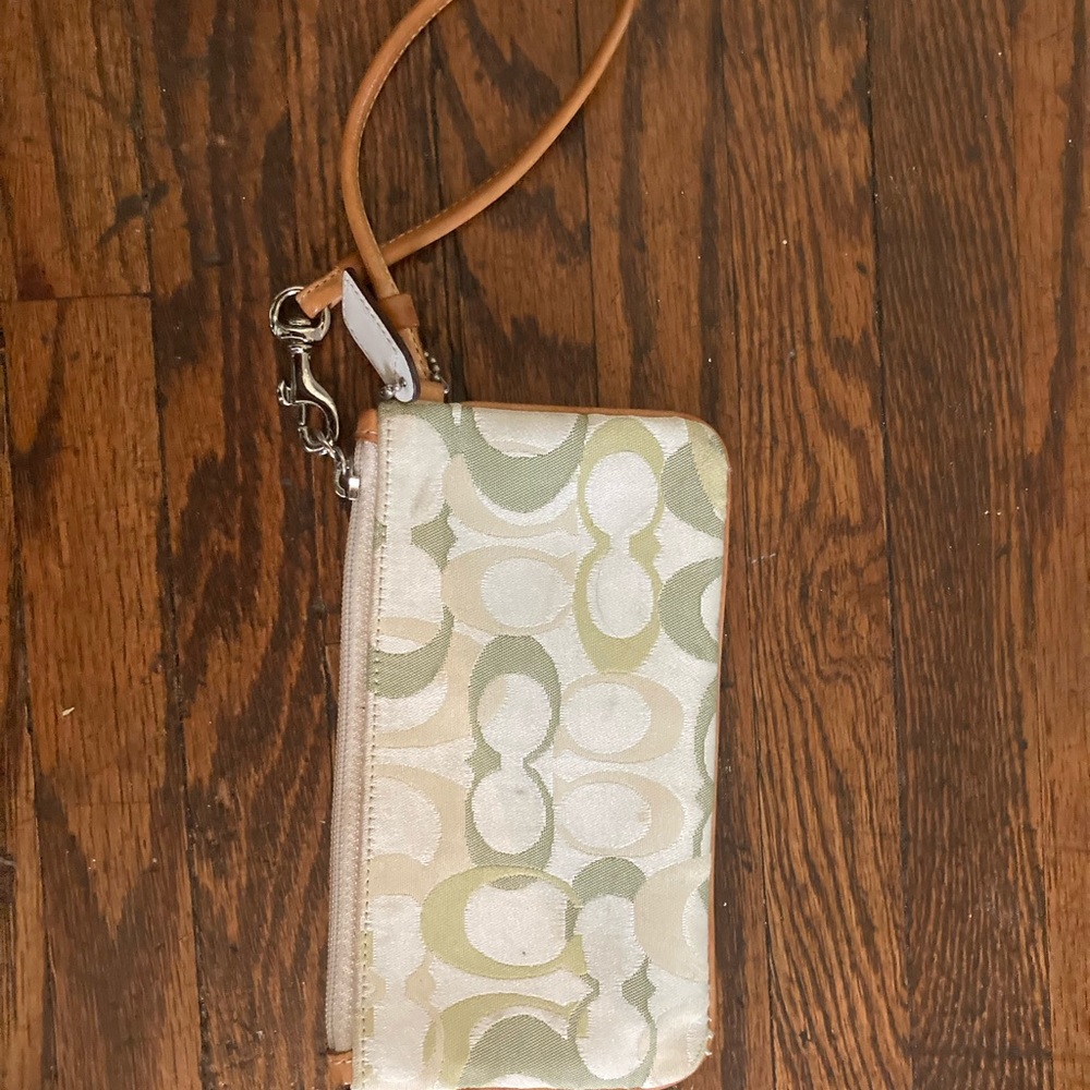 White and green Coach wristlet
